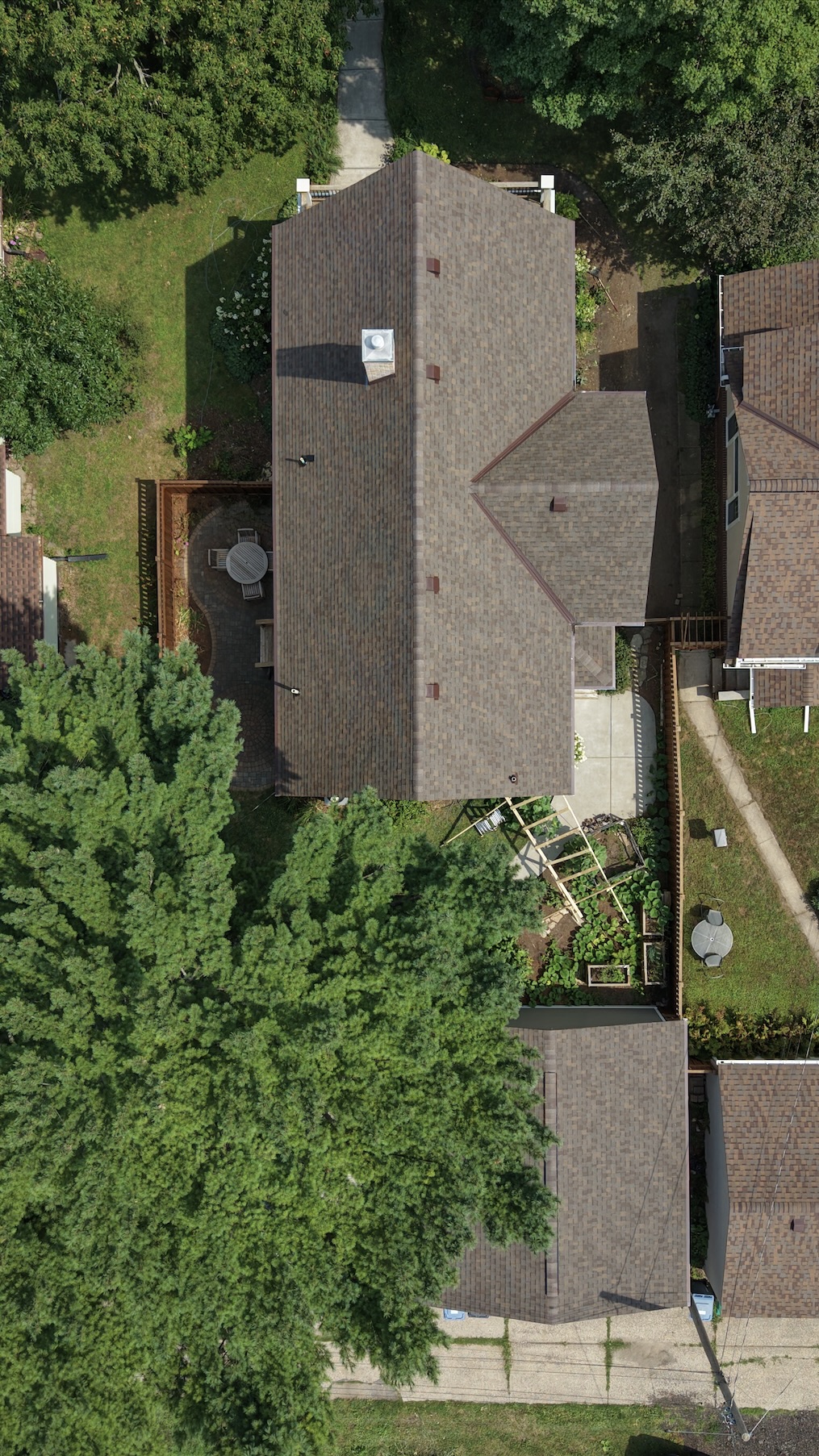 Aerial drone view of a Roseville, MN home during a free roof estimate by Midwest Building Exteriors