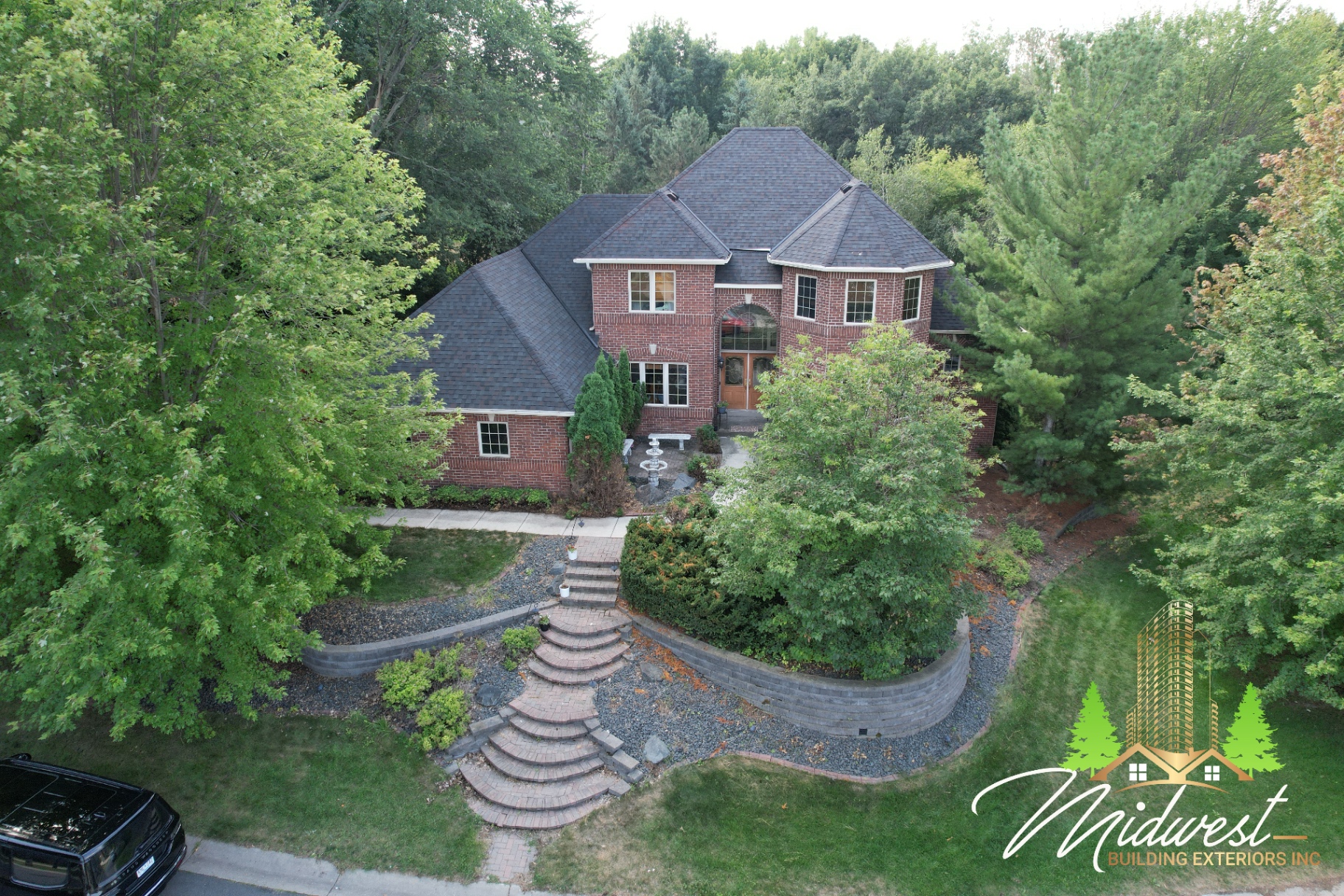 Brick estate asphalt roof in wooded lot — Edina, MN