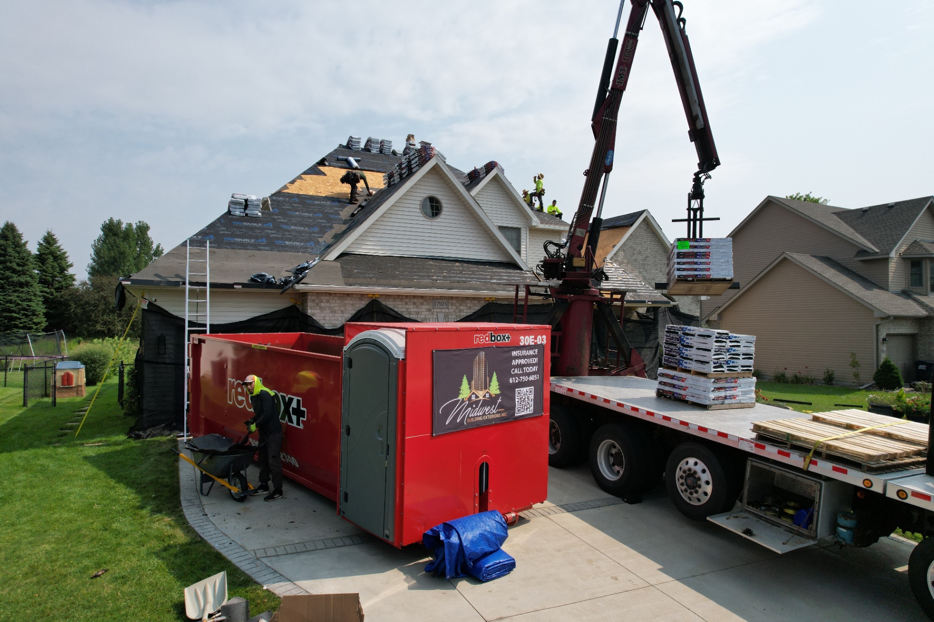 Storm-damage roof replacement with crane delivery and staged material bundles