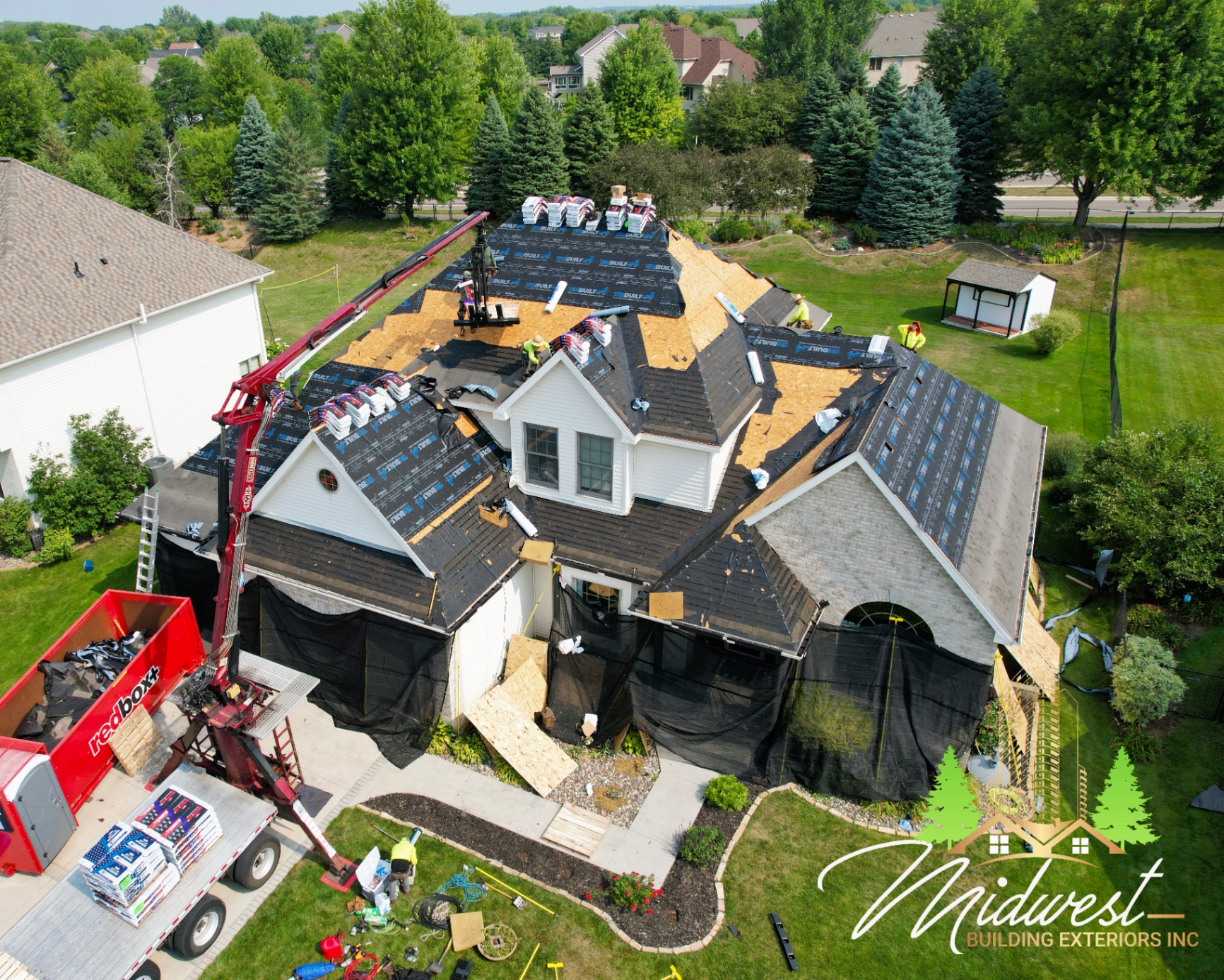 Storm-damage roof replacement project photographed from above during active installation