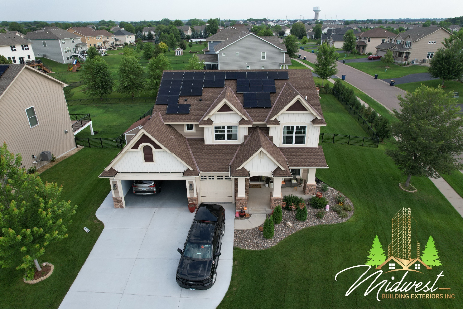 Aerial insurance-claim roof project on large home with solar panels and storm restoration scope — Lakeville, MN