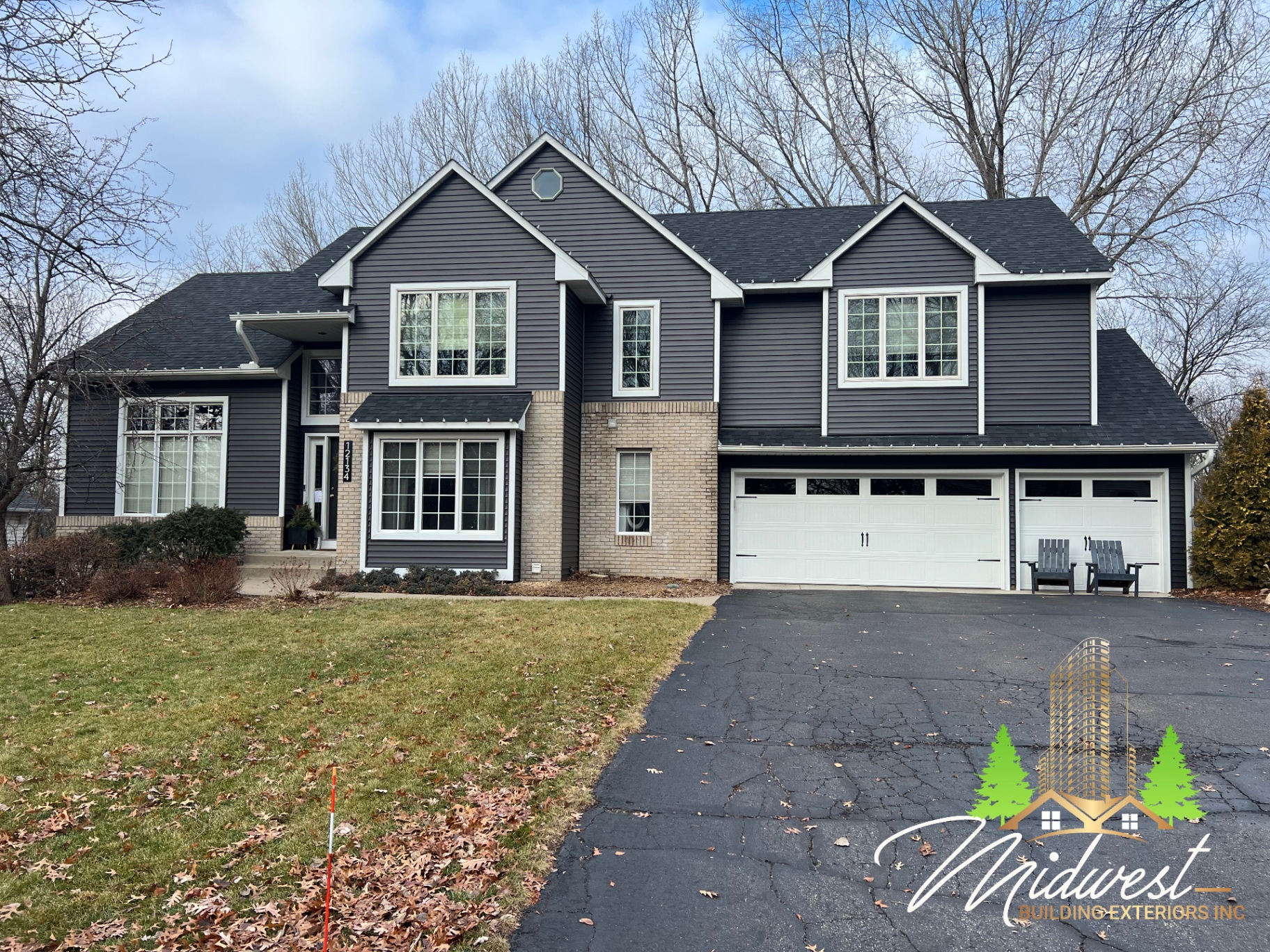 Completed charcoal lap siding on two-story home with three-car garage — Apple Valley, MN