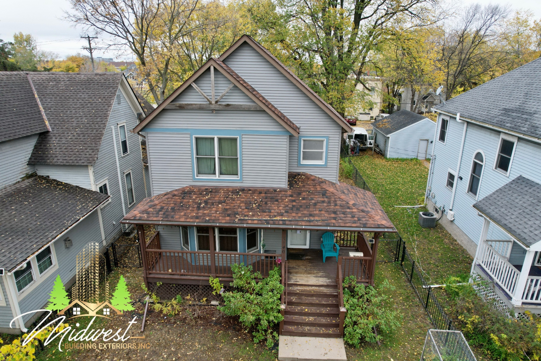 Aerial view of grey craftsman home with covered front porch siding project — St. Paul, MN