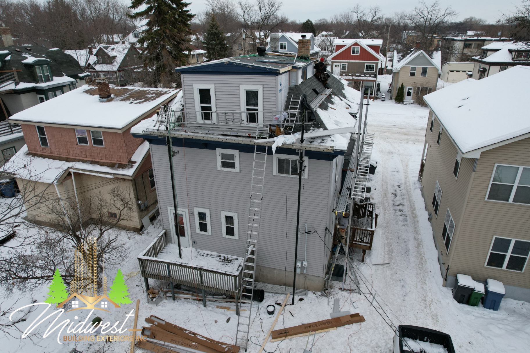 Winter siding replacement on urban duplex with scaffold staging — Minneapolis, MN